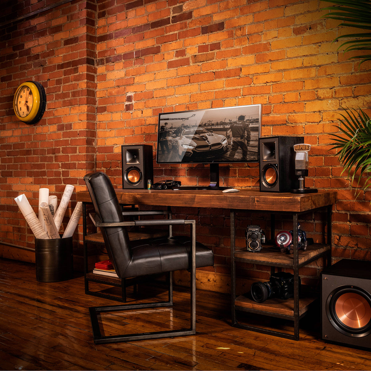 Klipsch R-51PM active bookshelf speakers with black cabinets and front-facing control knobs, designed for high-quality audio.