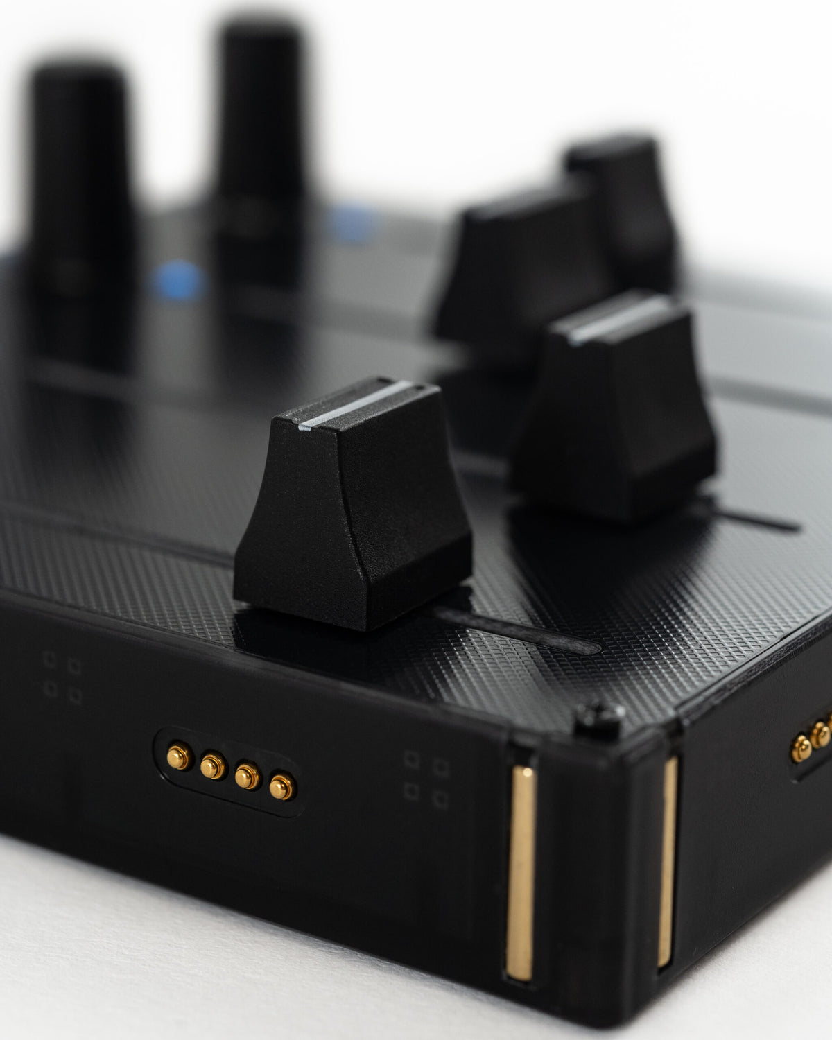 Close-up of Intech Studio EF44 Detent Series 3 MIDI controller with knobs and switches for music production.