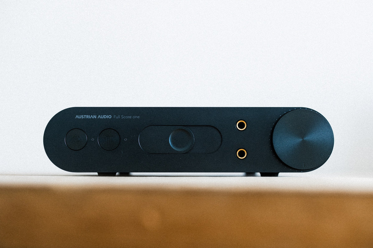 Austrian Audio Full Score One headphone amplifier and DAC with sleek black design and control knobs on top.