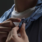 Hollyland Lark M3 transmitter attached to a jacket collar with the magnet