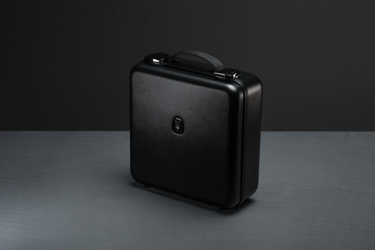 Closed case of Meze Audio Empyrean II wired headphones in a sleek suitcase, showcasing the premium design and high-quality build.