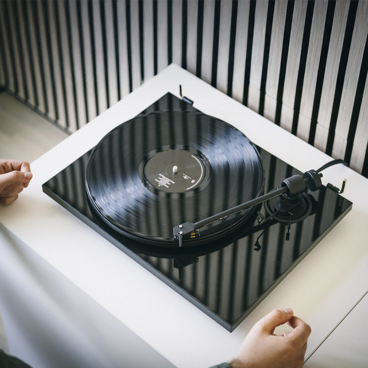 Pro-Ject E1.2 BT in high gloss black playing a record