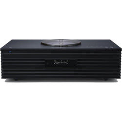 Technics SC-C70MK2 CD player with sleek design, digital display, and control buttons on top, in a modern home audio setup.